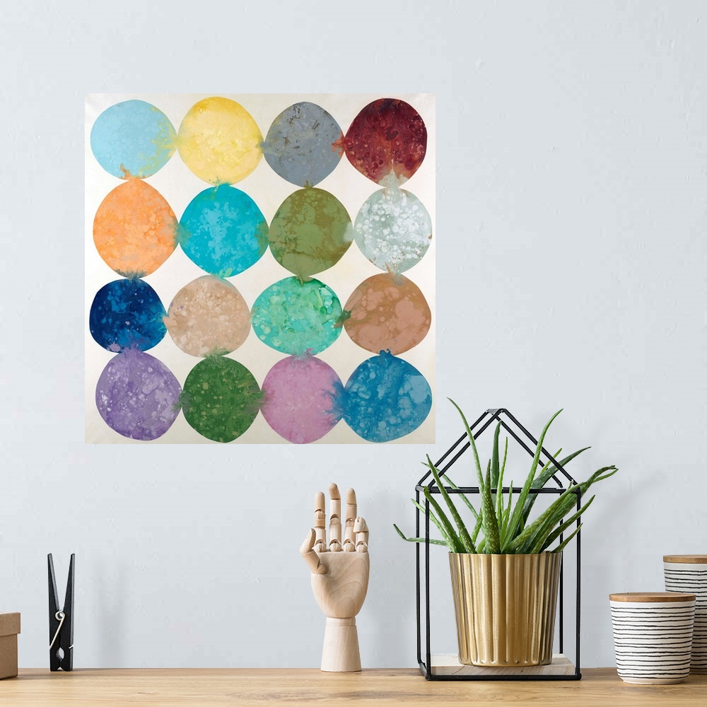 A bohemian room featuring Abstract artwork with colorful circles placed together in rows with their hues bleeding into the ...