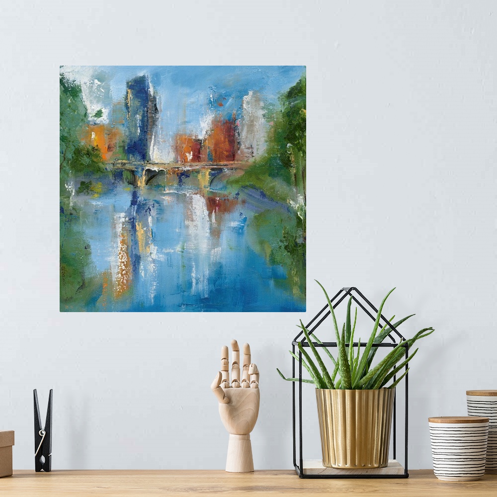 A bohemian room featuring Square abstract painting of a city skyline and a bridge reflecting into water with trees on the s...