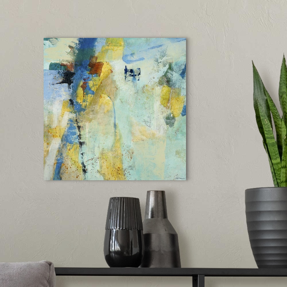 A modern room featuring Contemporary abstract painting using mostly blue tones with patches of pale yellow.