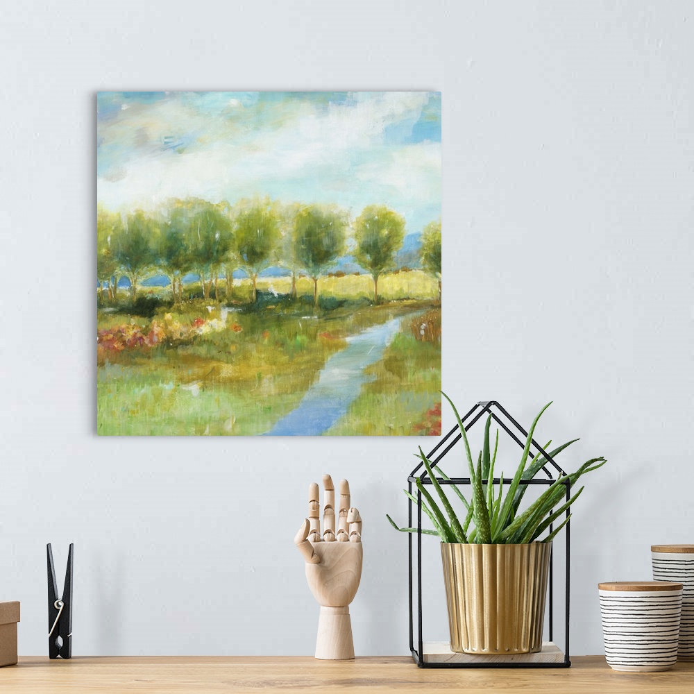 A bohemian room featuring Contemporary landscape painting with a line of bright green trees.