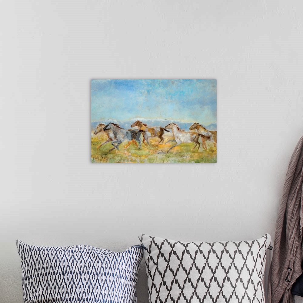 A bohemian room featuring A landscape painting of wild horses running across the plains; the horses have been painted with ...