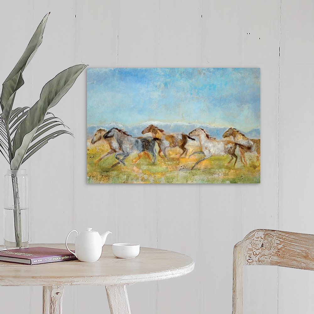 A farmhouse room featuring A landscape painting of wild horses running across the plains; the horses have been painted with ...