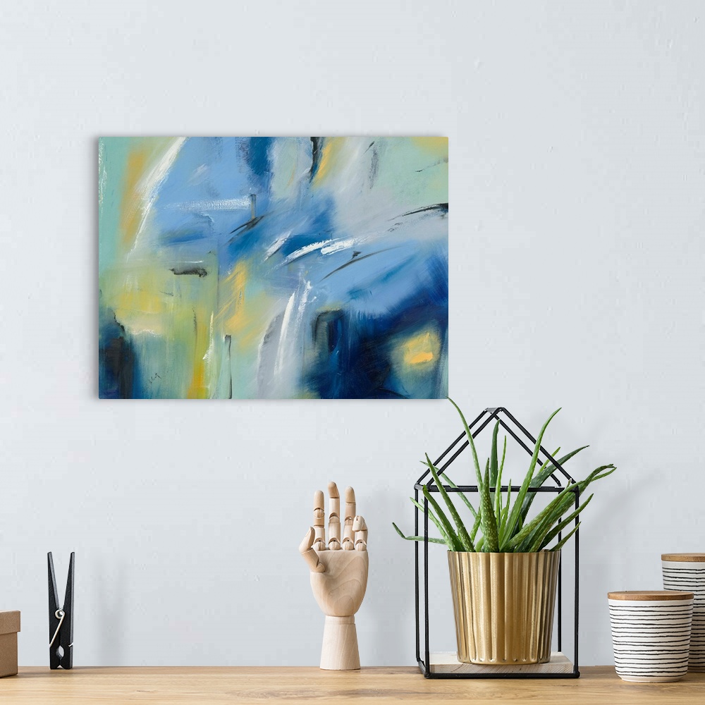 A bohemian room featuring Large blue, green, and yellow abstract painting with black and white brushstrokes on top creating...