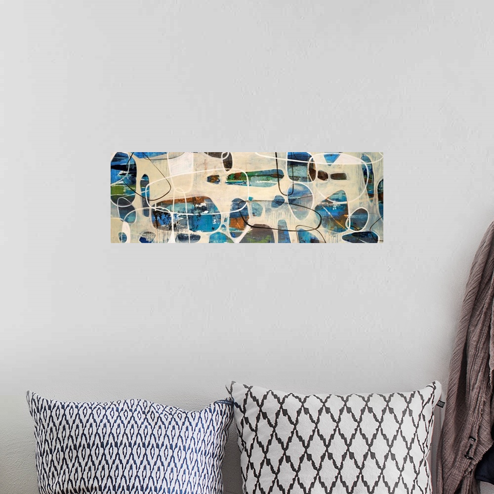 A bohemian room featuring Abstract painting of oval, stone like shapes scattered on a panoramic sized art canvas.