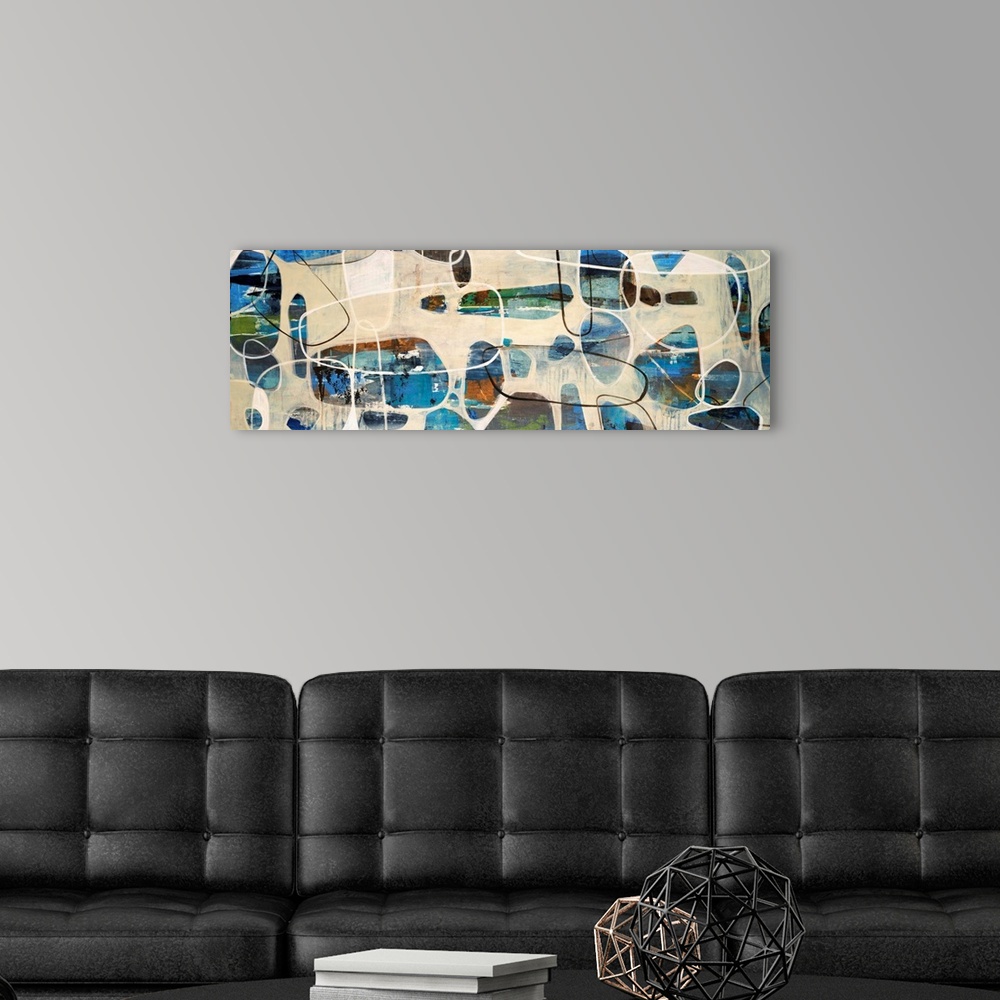 A modern room featuring Abstract painting of oval, stone like shapes scattered on a panoramic sized art canvas.