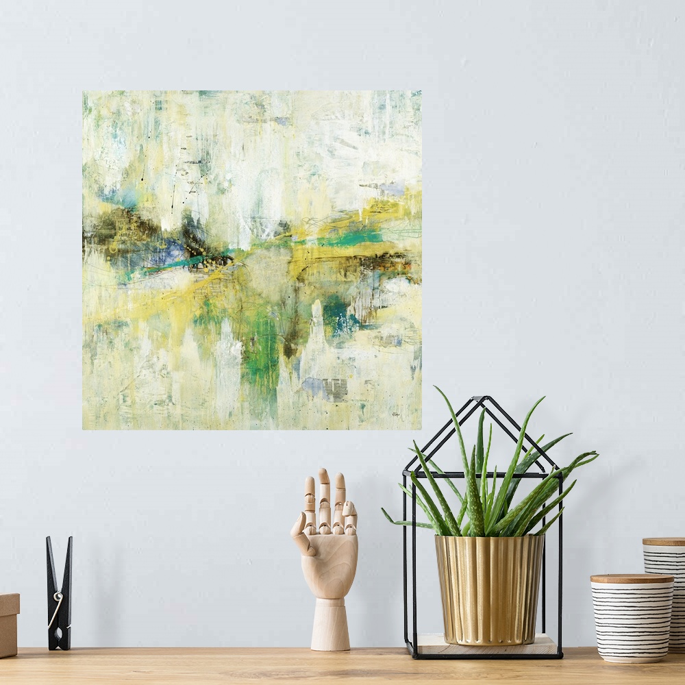 A bohemian room featuring A colorful abstract painting of green, yellow and blue with thin black speckles throughout.