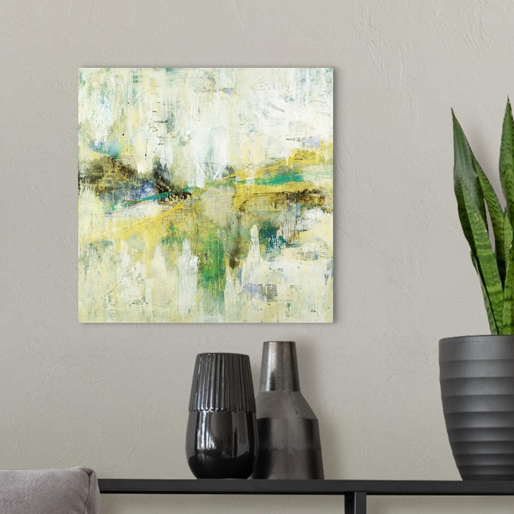 A modern room featuring A colorful abstract painting of green, yellow and blue with thin black speckles throughout.