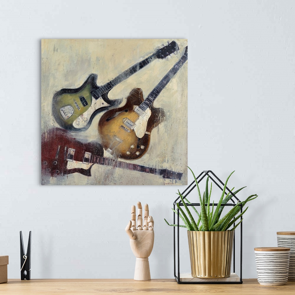A bohemian room featuring Painting of three different color guitars on a textured neutral color background.