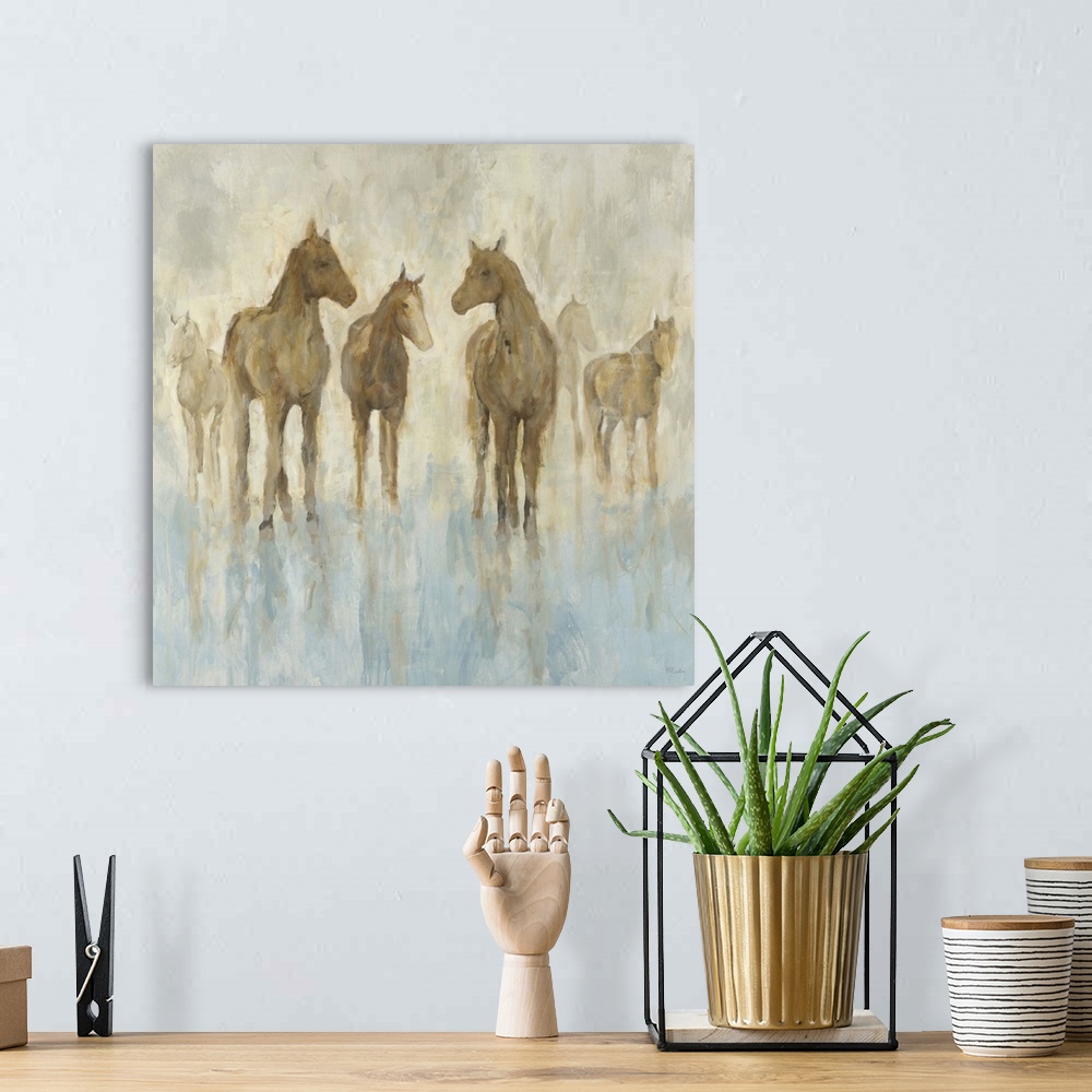 A bohemian room featuring Contemporary painting of a small group of horses standing in a soft blue environment.