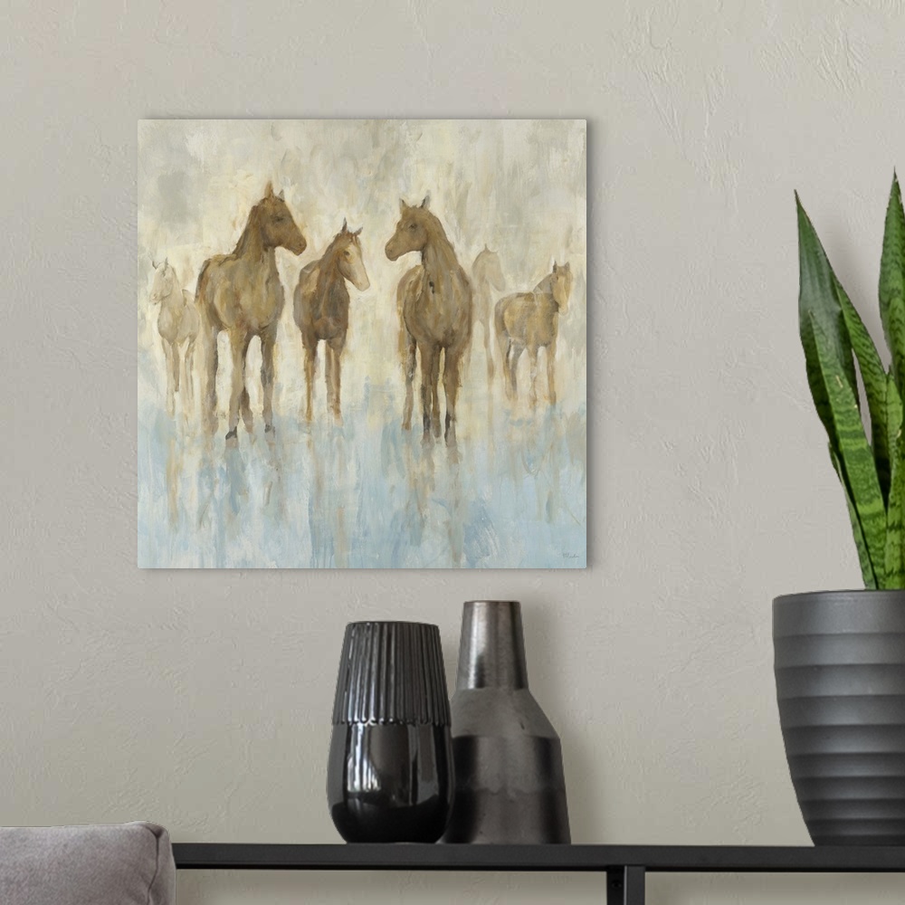 A modern room featuring Contemporary painting of a small group of horses standing in a soft blue environment.