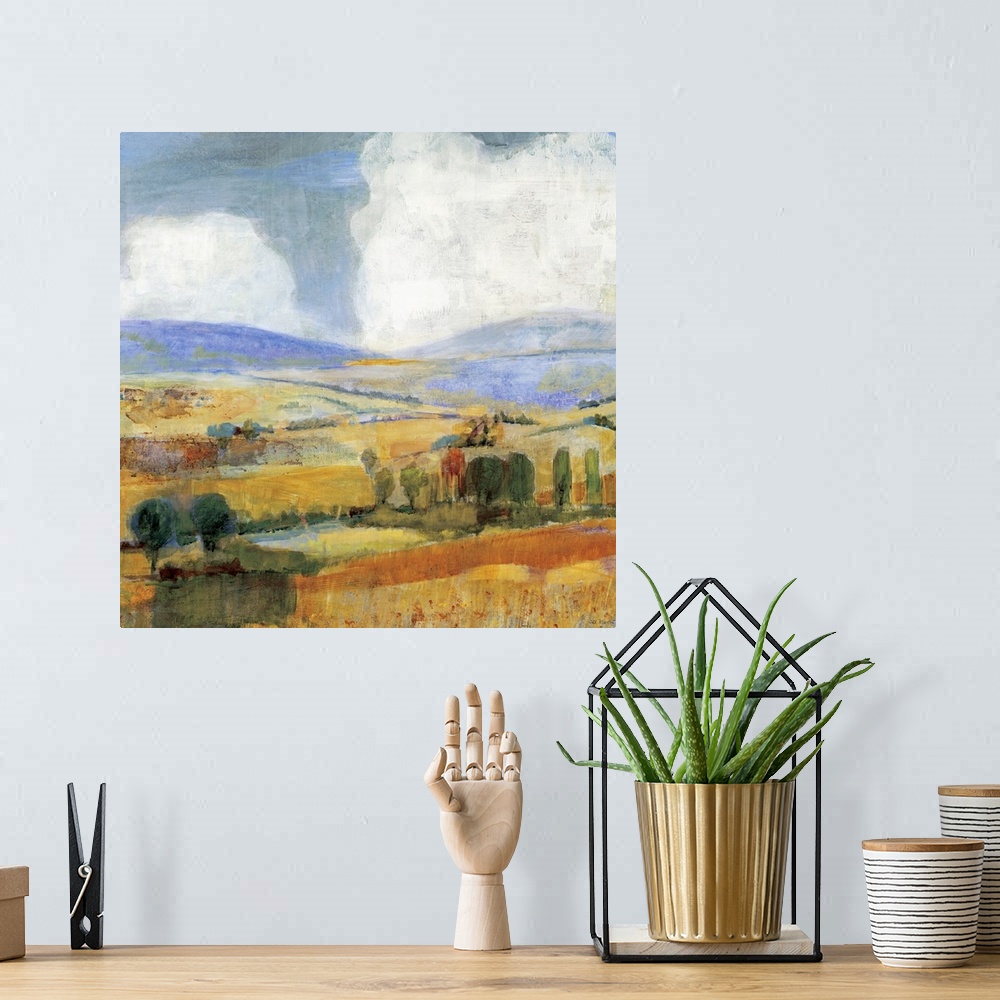 A bohemian room featuring Square contemporary painting of a golden countryside of rolling hills and trees beneath a sky wit...