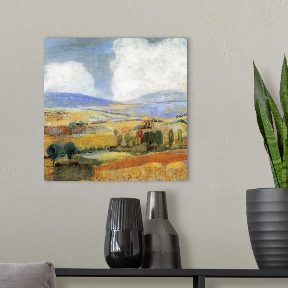 A modern room featuring Square contemporary painting of a golden countryside of rolling hills and trees beneath a sky wit...