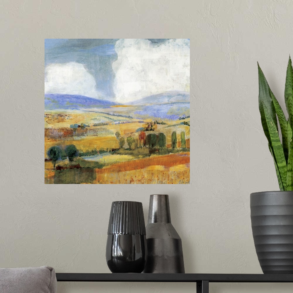 A modern room featuring Square contemporary painting of a golden countryside of rolling hills and trees beneath a sky wit...