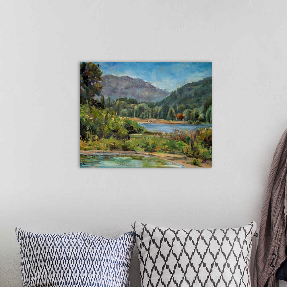 A bohemian room featuring Contemporary landscape painting with a mountain in the background.