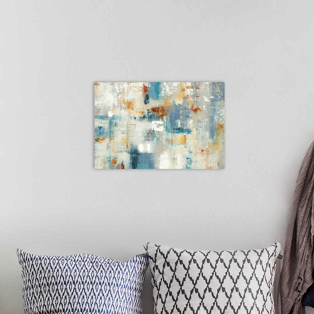 A bohemian room featuring Large abstract painting with shades of blue, yellow, orange, gray, and white.