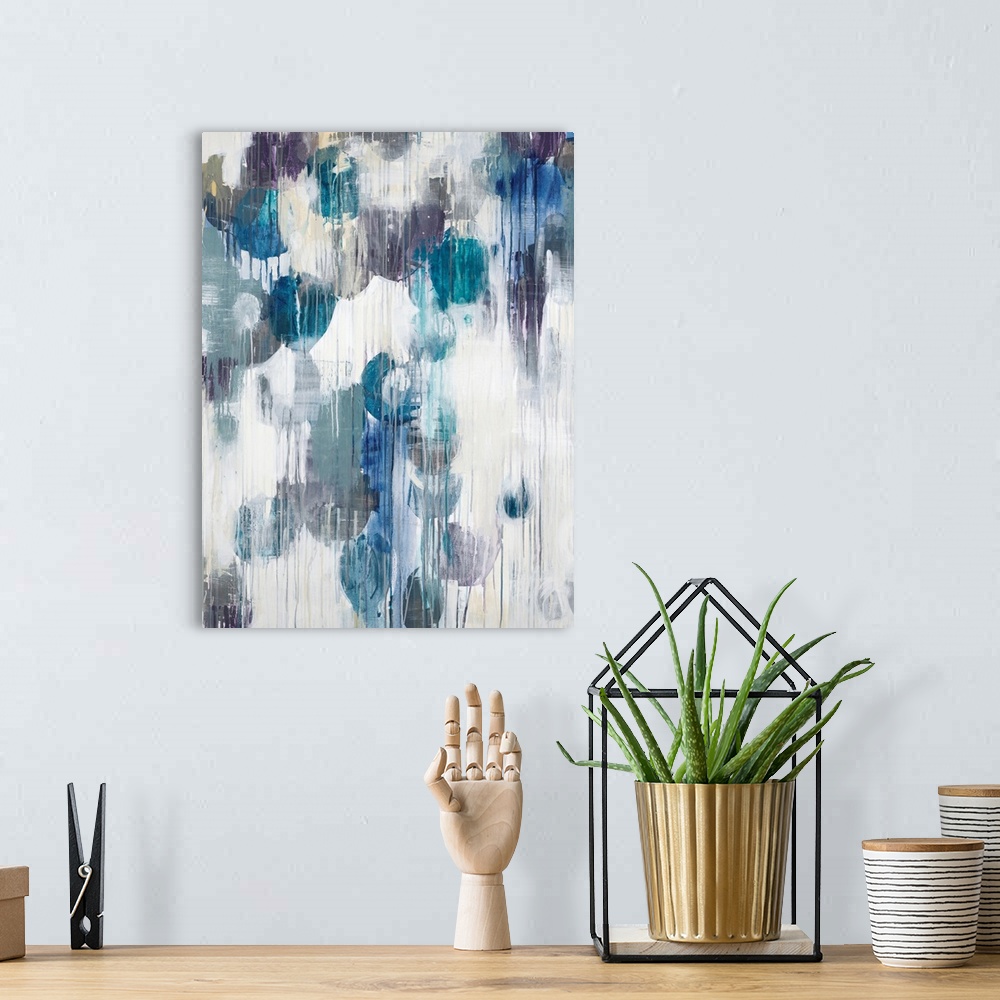 A bohemian room featuring Abstract art piece of cool color paint blotches with the paint dripping down.