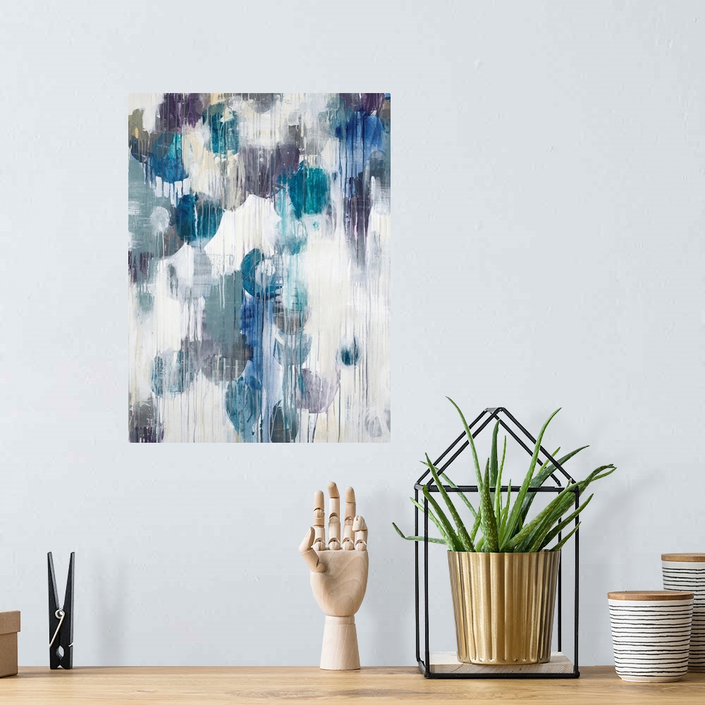 A bohemian room featuring Abstract art piece of cool color paint blotches with the paint dripping down.