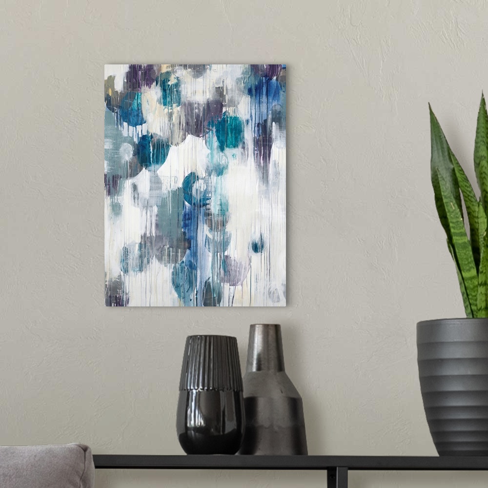 A modern room featuring Abstract art piece of cool color paint blotches with the paint dripping down.