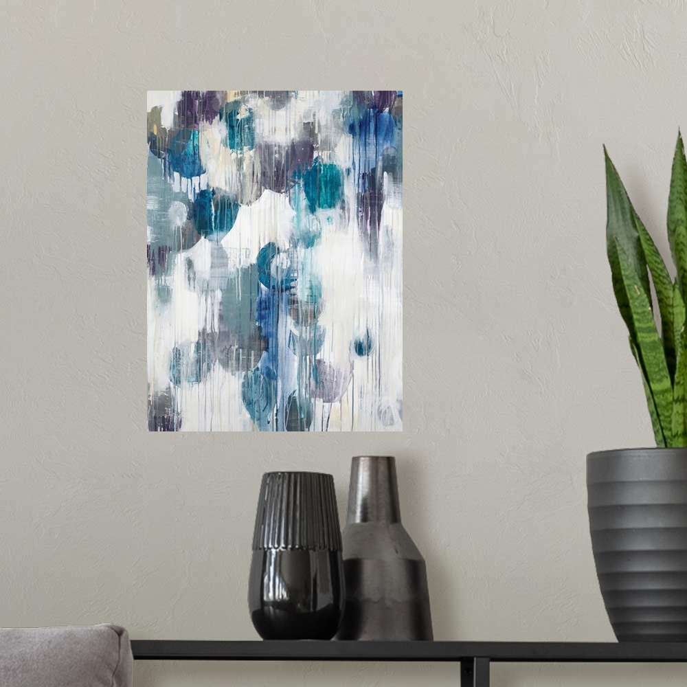 A modern room featuring Abstract art piece of cool color paint blotches with the paint dripping down.