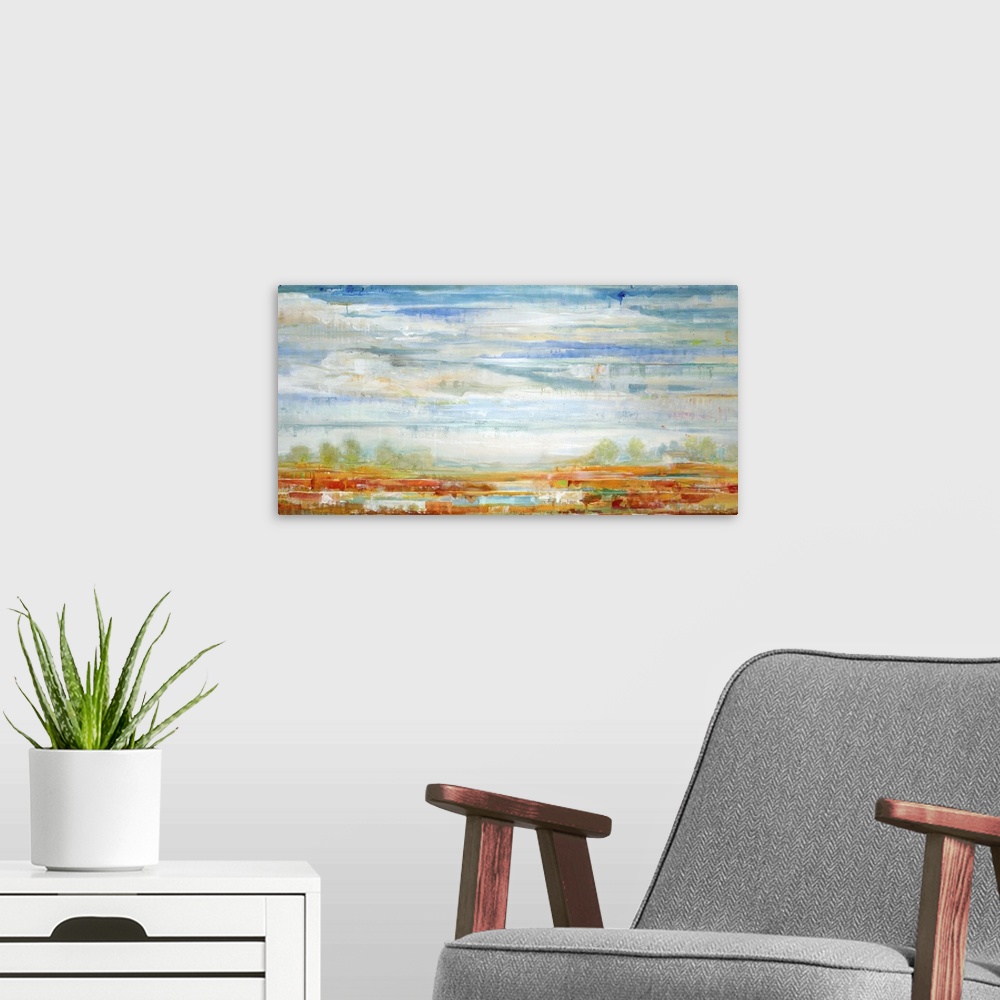 A modern room featuring Contemporary landscape painting looking out over red fields under a vibrant blue cloudy sky.