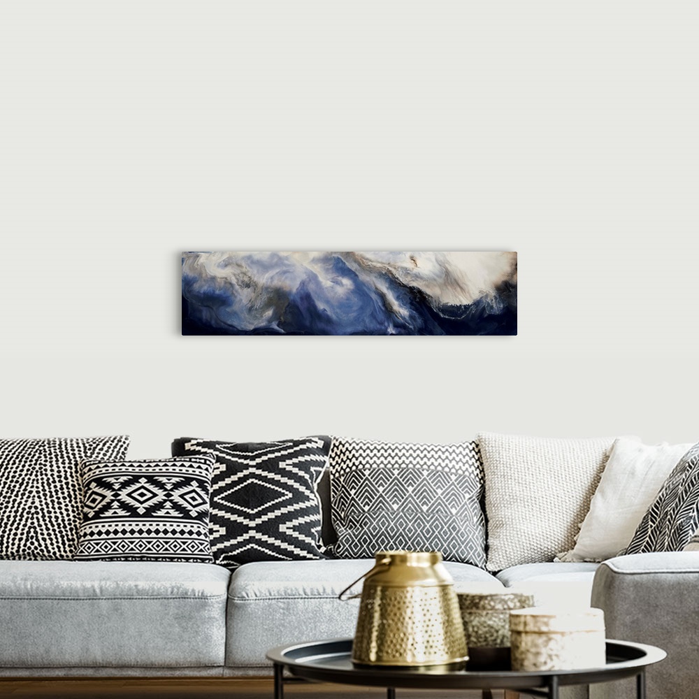 A bohemian room featuring Panoramic abstract painting with deep blue hues forming together with brown and white hues to cre...