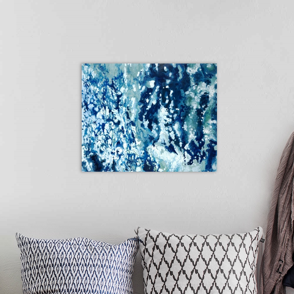 A bohemian room featuring Abstract painting with shades of blue marbled together with white.