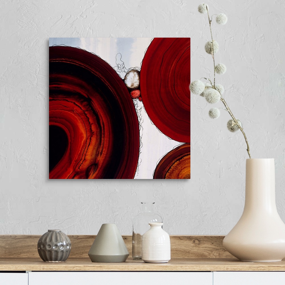 A farmhouse room featuring Abstract painting with a geometric circle designs in red and orange tones on a faded blue and whi...
