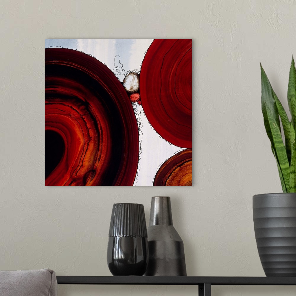 A modern room featuring Abstract painting with a geometric circle designs in red and orange tones on a faded blue and whi...