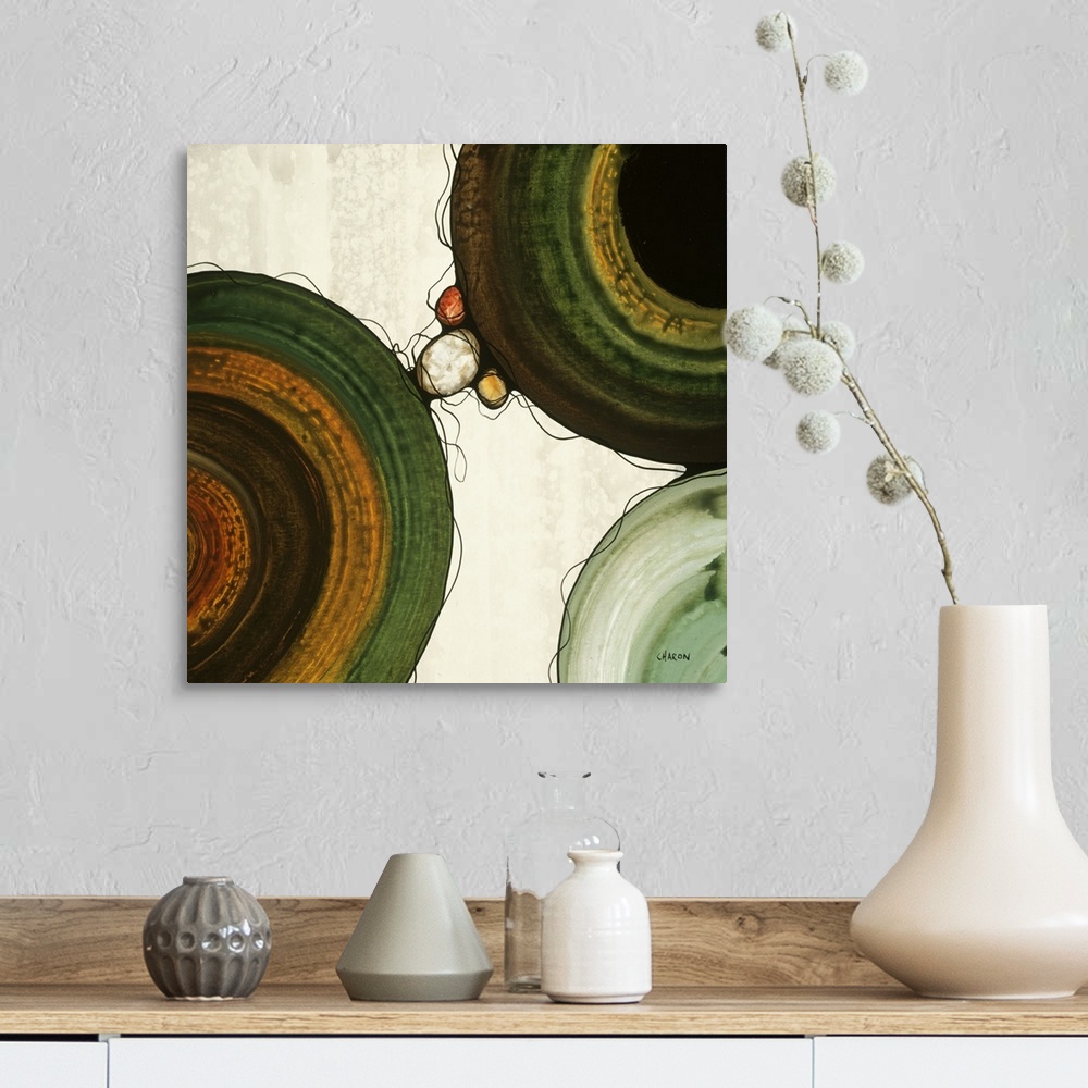 A farmhouse room featuring Abstract painting with a geometric circle designs in orange, yellow, green, and brown tones on a ...
