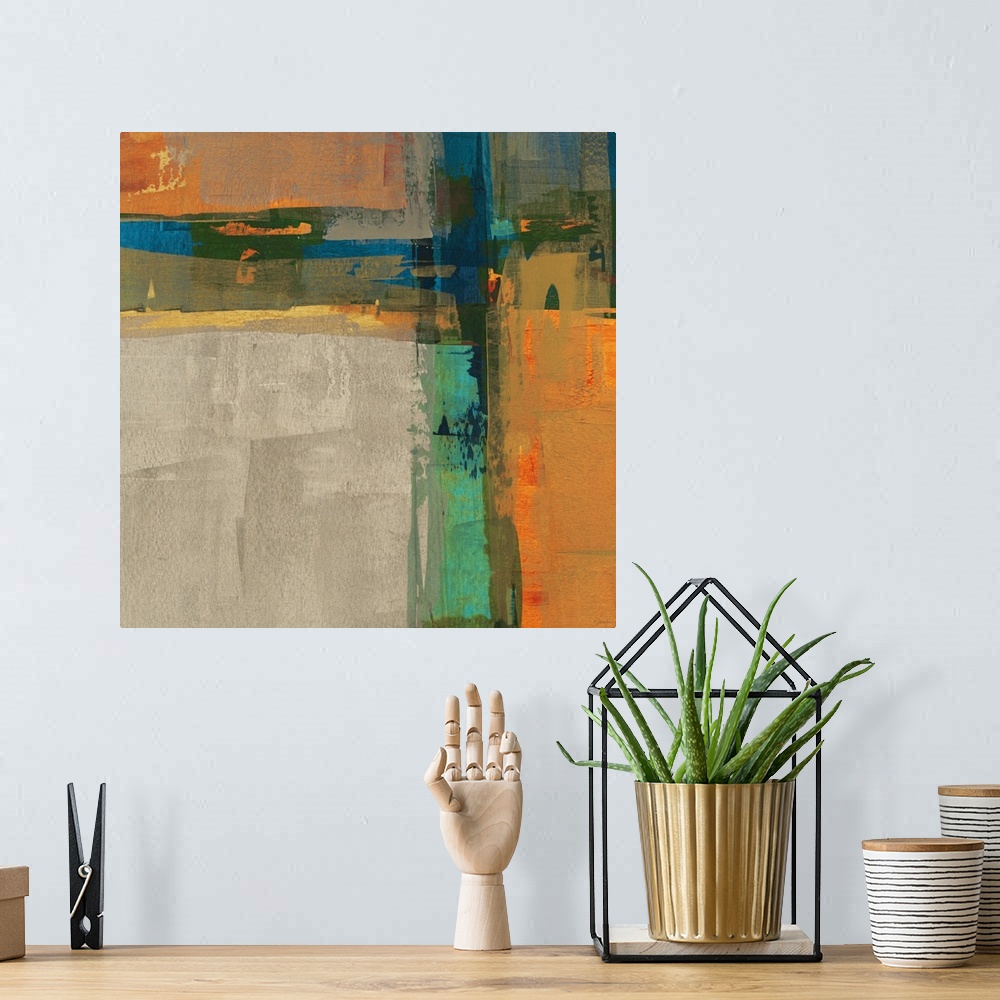 A bohemian room featuring A bright square abstract painting of thick crossing colors of orange, blue, yellow and green.