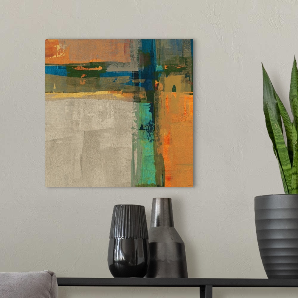 A modern room featuring A bright square abstract painting of thick crossing colors of orange, blue, yellow and green.