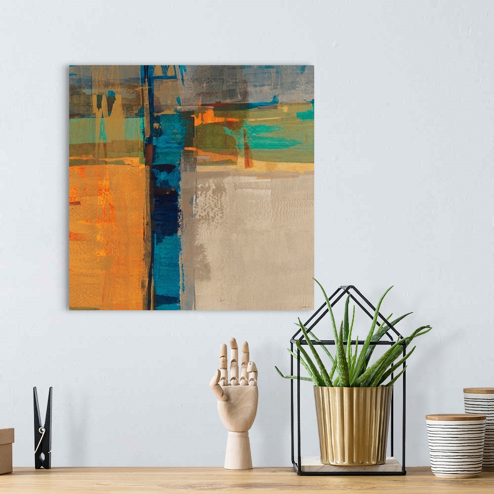A bohemian room featuring A bright square abstract painting of thick crossing colors of orange, blue, yellow and green.