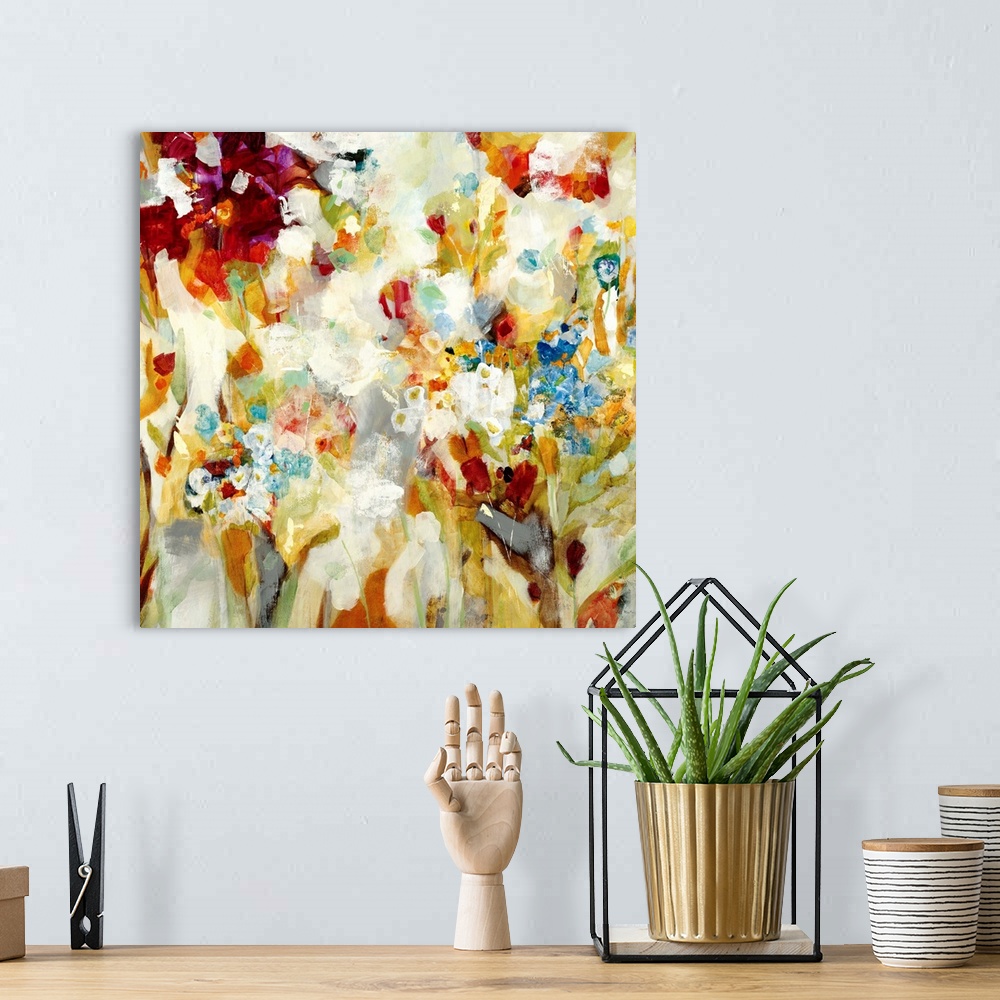 A bohemian room featuring An abstract piece that has a variety of colors painted loosely to resemble flowers.