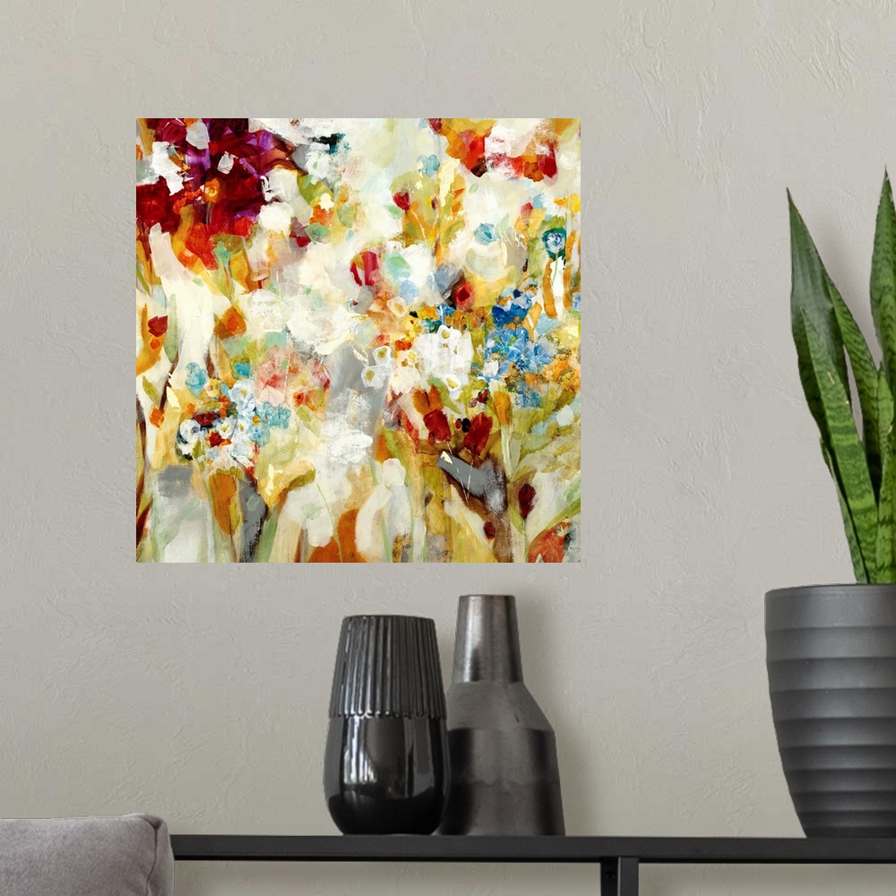 A modern room featuring An abstract piece that has a variety of colors painted loosely to resemble flowers.