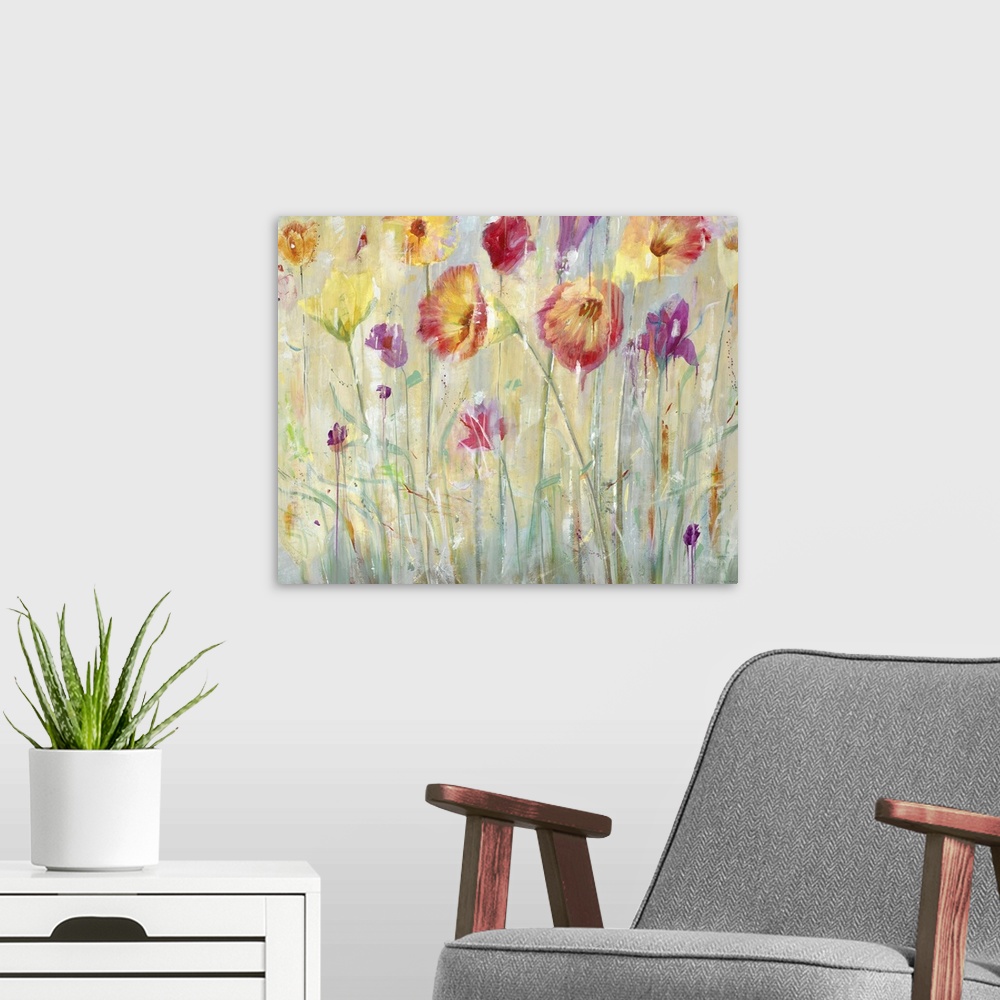 A modern room featuring A contemporary painting of vibrant red purple and yellow flowers in a garden.