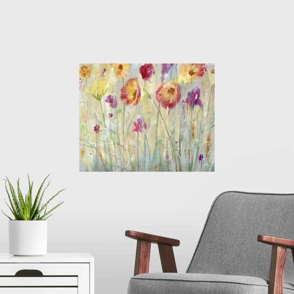 A modern room featuring A contemporary painting of vibrant red purple and yellow flowers in a garden.