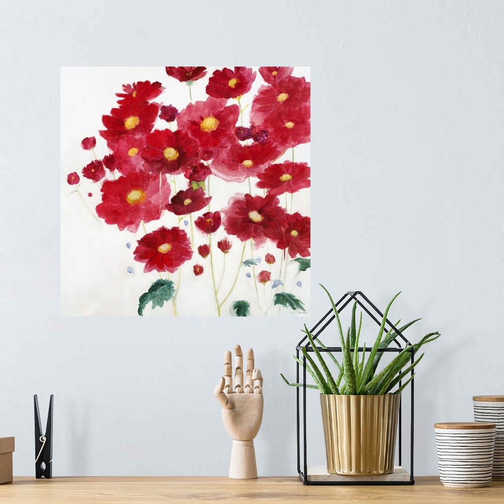 A bohemian room featuring A contemporary painting of vibrant red flowers against a white background.