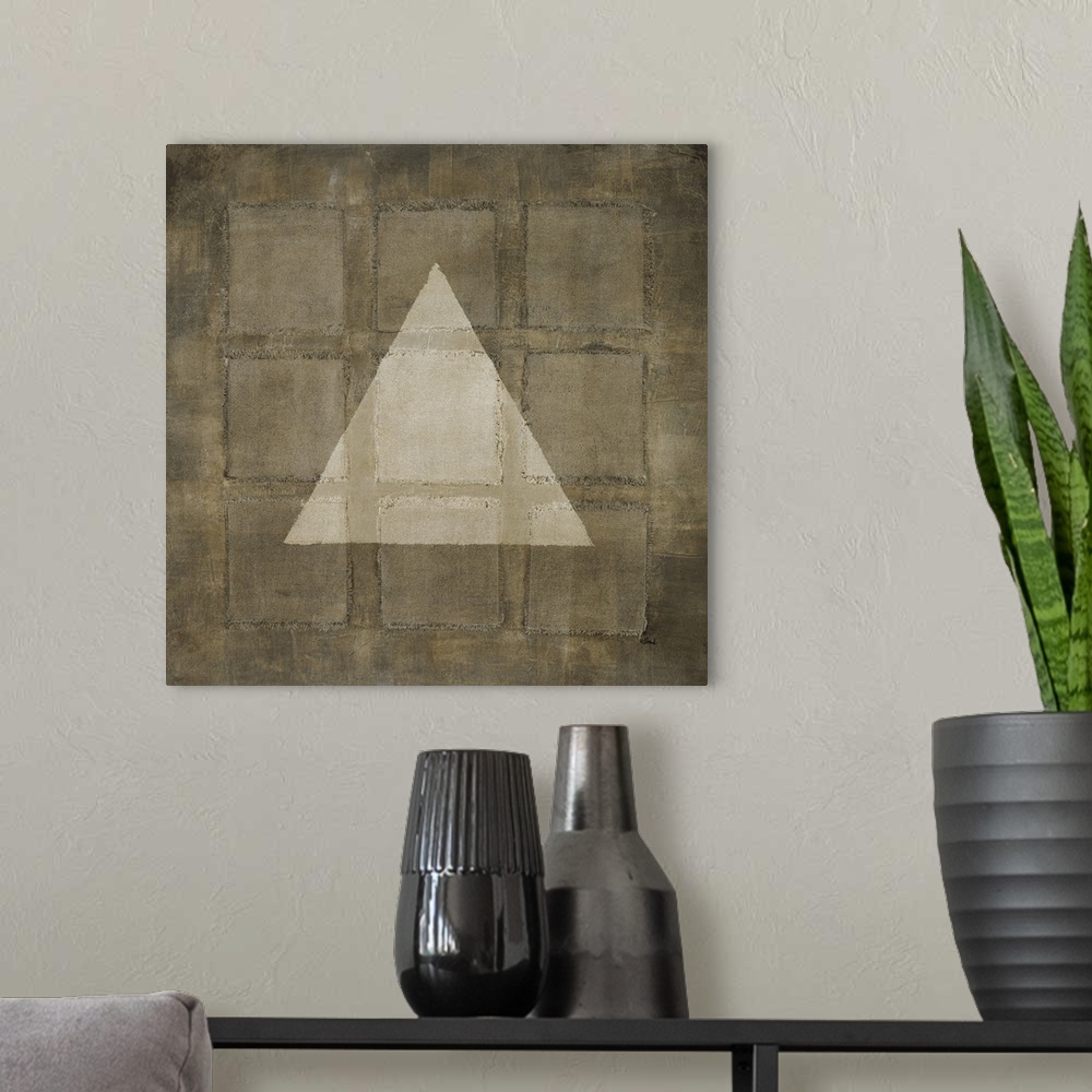 A modern room featuring A modern painting of nine squares with a light colored triangle overlapping, all in varies shades...