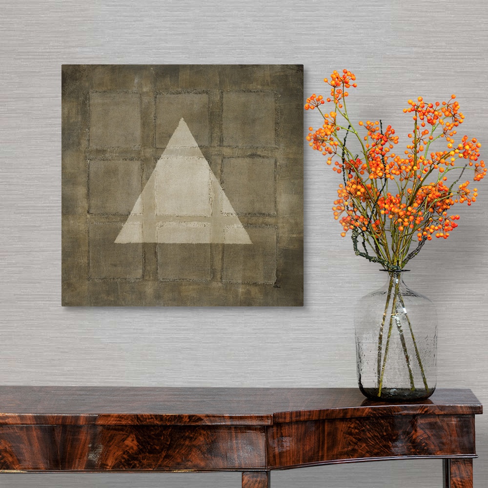 A traditional room featuring A modern painting of nine squares with a light colored triangle overlapping, all in varies shades...