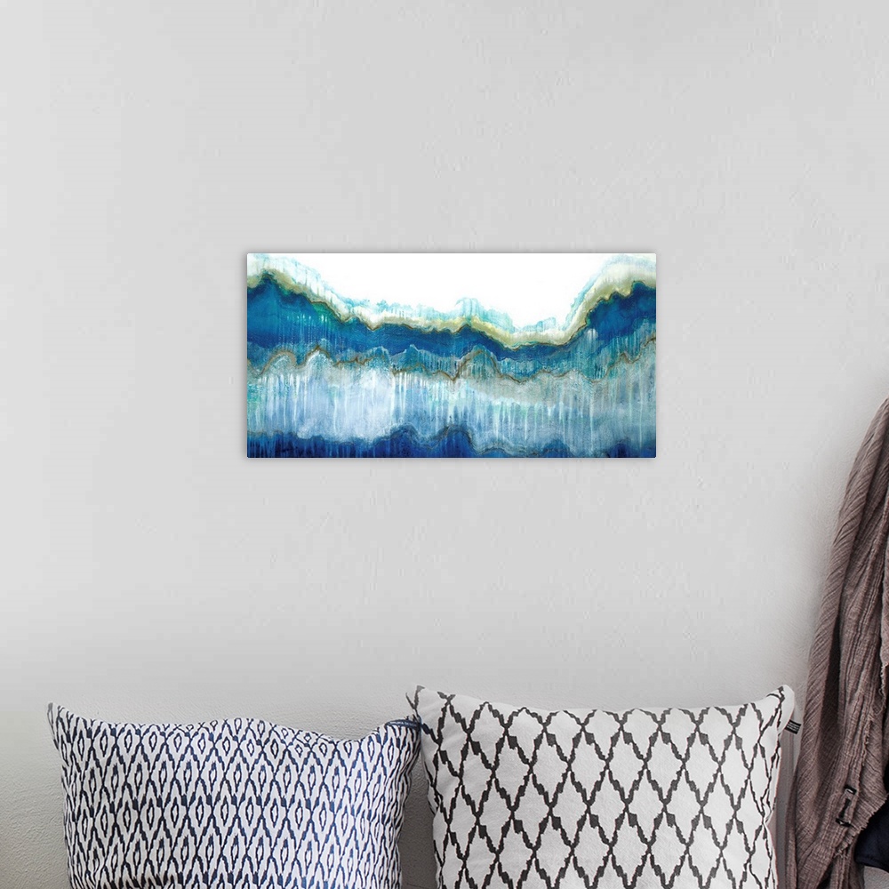 A bohemian room featuring Large abstract painting in shades of blue, green, brown, and gray representing a large wave.