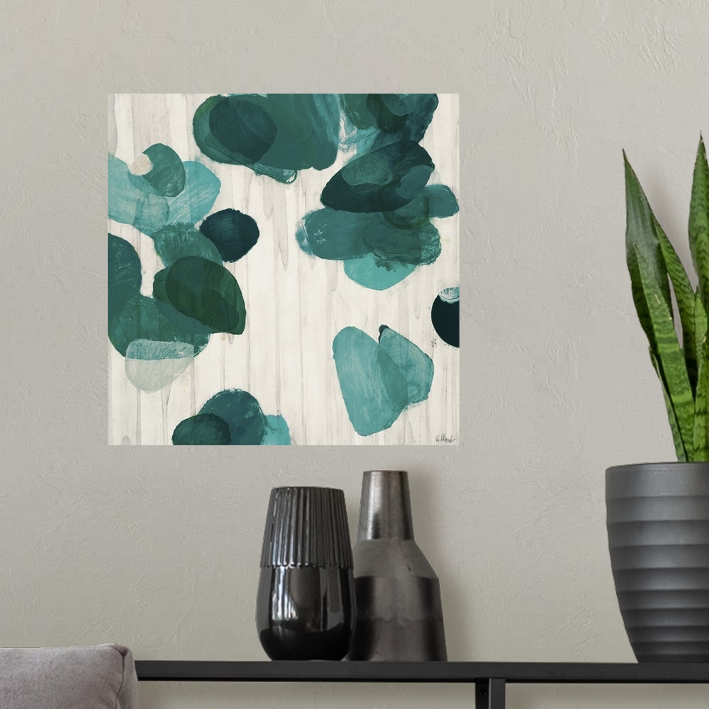 A modern room featuring A contemporary abstract painting of teal green flake shapes against a neutral toned background.