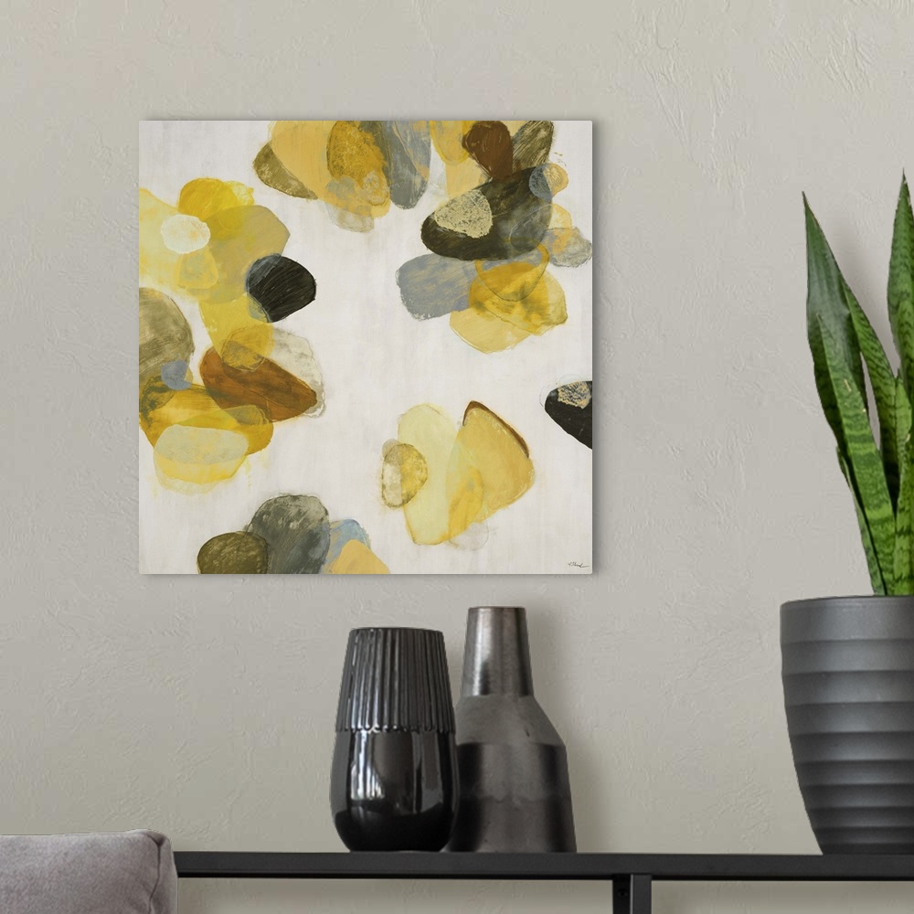 A modern room featuring A contemporary abstract painting of golden yellow flake shapes against a neutral toned background.