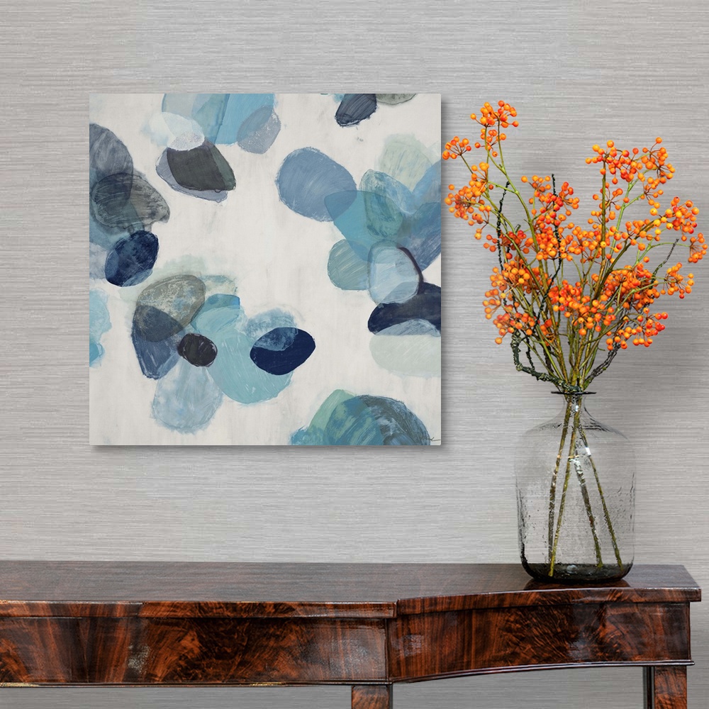 A traditional room featuring A contemporary abstract painting of blue flake shapes against a neutral toned background.