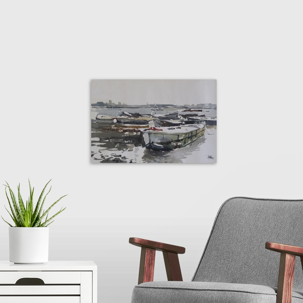 A modern room featuring This pensive artwork features earthy tones and illustrates abandoned old barges at the shore of T...