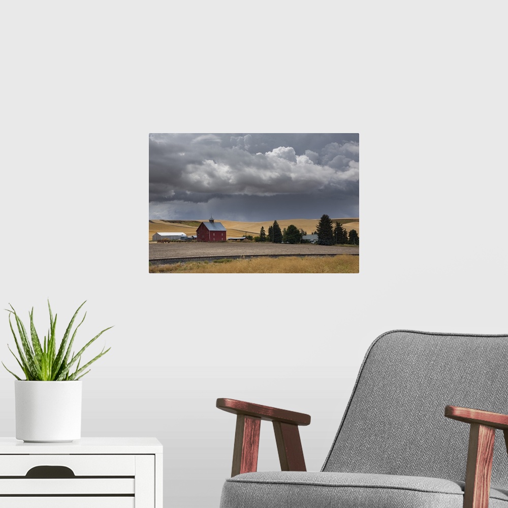A modern room featuring Dark storm clouds over a red barn in Palouse, Washington.