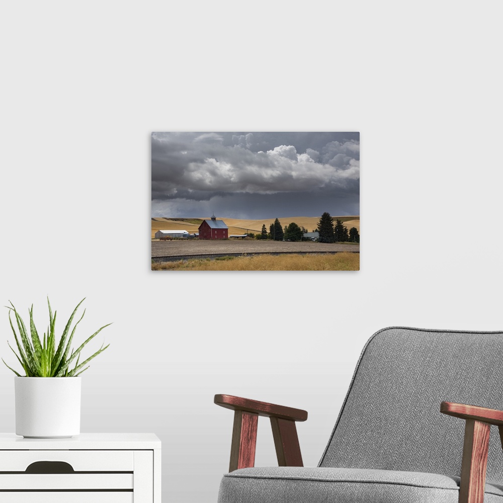 A modern room featuring Dark storm clouds over a red barn on a farm in Palouse, Washington.