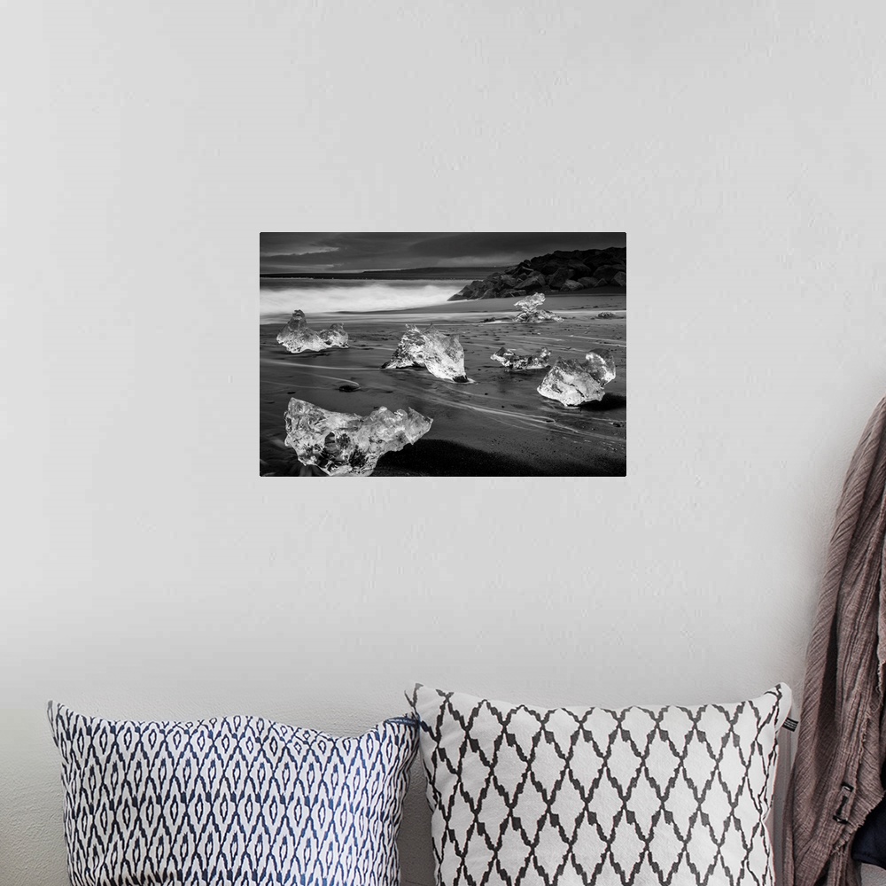 A bohemian room featuring Fragments of ice on the dark sand on the Icelandic coast.