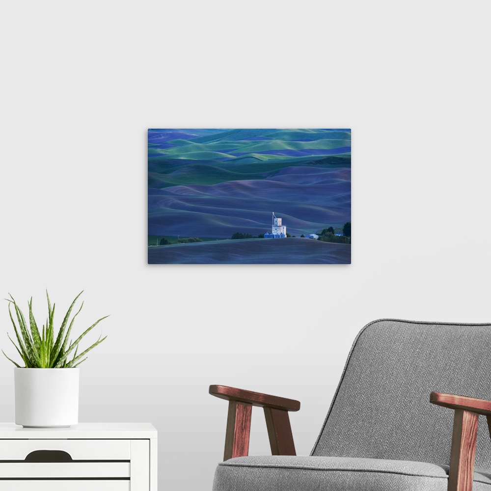 A modern room featuring A grain elevator stands out against the deep blue hills of Palouse, Washington.