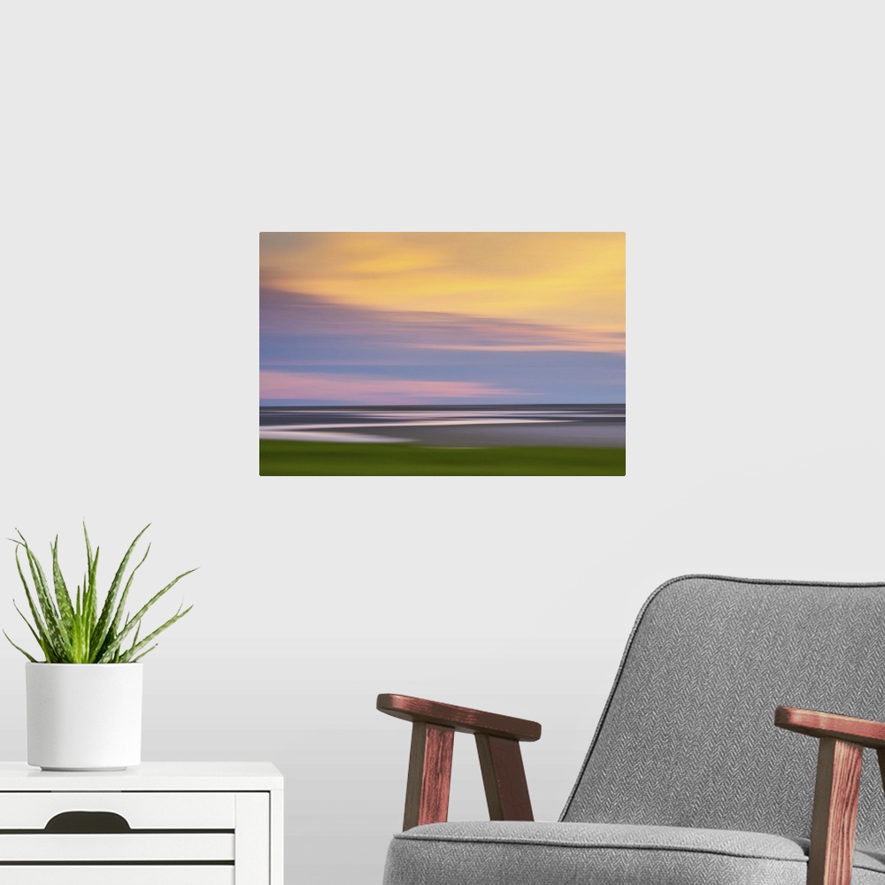 A modern room featuring Blurred image of the Atlantic coast at sunset, with a pastel cloudy sky.