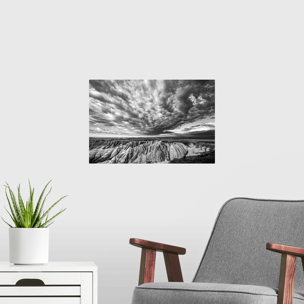 A modern room featuring Black and white photo of striking clouds over rock formations in the South Dakota Badlands.